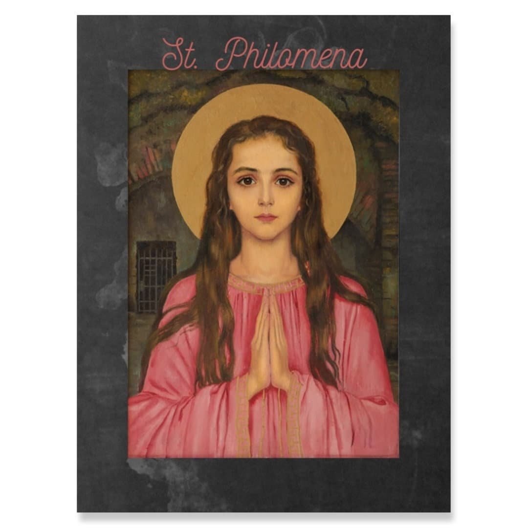May include: A painting of a young woman with long brown hair wearing a pink dress. She is praying with her hands clasped together. The painting is set against a dark background with a halo of light around her head. The title "St. Philomena" is written in cursive at the top of the painting.